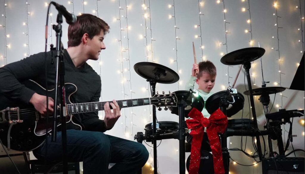student learning to play guitar